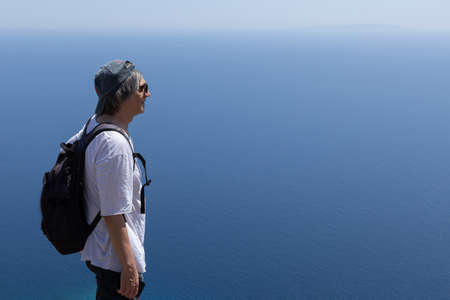 a man in dark glasses looks into the sea distance. Greece, Creteの写真素材
