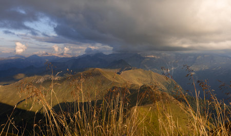 Autumn cloudy sky over alpine mountains in austriaの写真素材