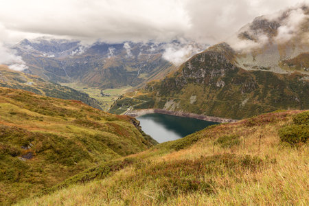 Autumn landscape of the Alpine mountains with reflection in the alpine lake. Austria, Salzburg, Gastein Valleyの写真素材