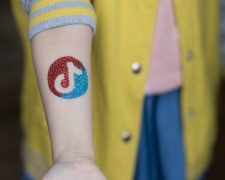 On the girls hand is a sticker with a bright festive coating.の写真素材