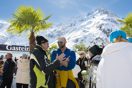 AUSTRIA, SPORTGASTEIN - March 18, 2023: Event Palmen auf den Almen, people actively communicate during the holidayのeditorial素材