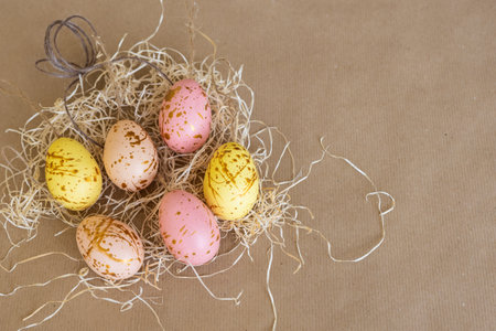 Six eggs in pastel colors lie on the hay and natural background, copies of Space, a concept of Easterの写真素材