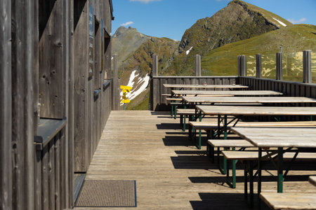 Exit from a mountain hut in the Alps to the signs of trekking routes