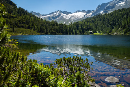 Mountain lake with the purest fresh water and a picturesque reflection of the surrounding snowy peaks, Austria, Reed Seeの写真素材