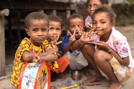 INDONESIA, ISLAND KRI - JANUARY 25, 2024: Little Papuan children pose for a street photographerのeditorial素材