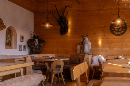 Cozy wooden dining area featuring unique decor and warm lighting in a rustic restaurant settingの写真素材