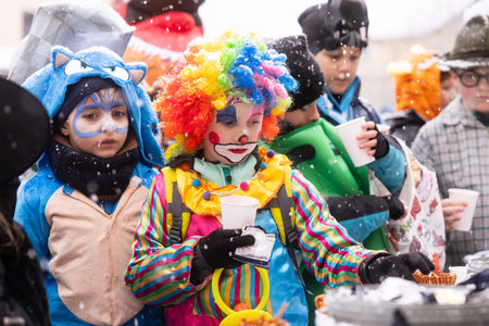 AUSTRIA, SALZBURGER LAND, BAD GASTEIN - FEBRUAR 17, 2026: Colorful clown child in costume at winter...