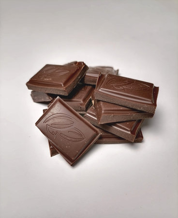 Pieces of chocolate on white background