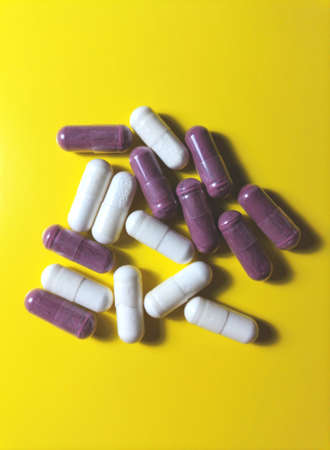 Capsules on a yellow backgroundの写真素材