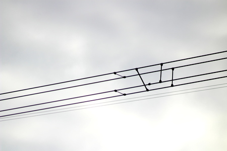 On the photo there are electrical supports, 330 kV power transmission lines, metal poles with insulators transmitting huge current over long distancesの写真素材