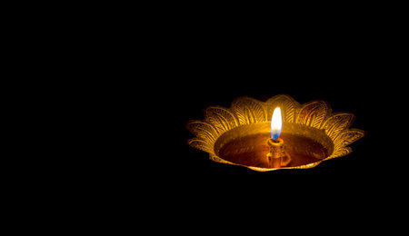 Diwali diya or oil lamp on black background. Hindu festival of lights.の写真素材