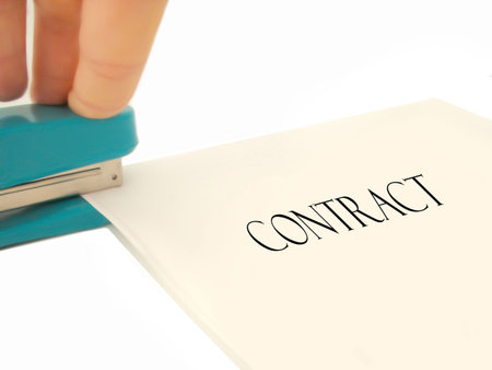 pages of a contract being stapled