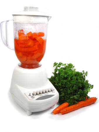 isolated blender making carrot juiceの写真素材