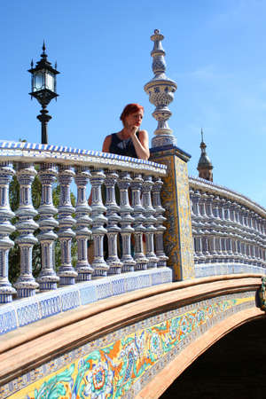 Woman on bridge at Plaza de Espana in Seville, Spainの写真素材