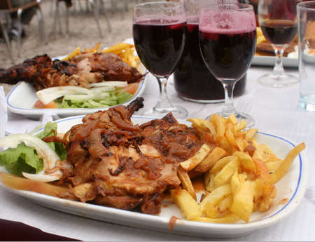 chicken,french fries and sangria at an outdoor restaurantの写真素材