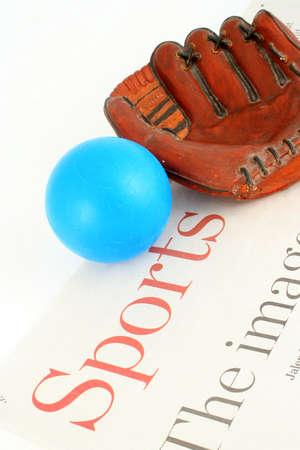 sports section of newspaper and ball with mittの写真素材