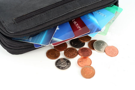 wallet with credit cards and change scattered about