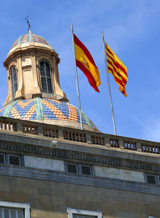 Spanish flags waving in the wind above the Palau de la Generalitatの写真素材