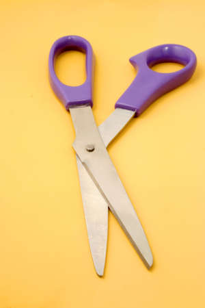 a pair of scissors on yellow backgroundの写真素材