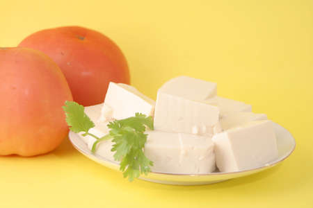 vegetarian food (tomato and tofu with a sprig of coriander)の写真素材