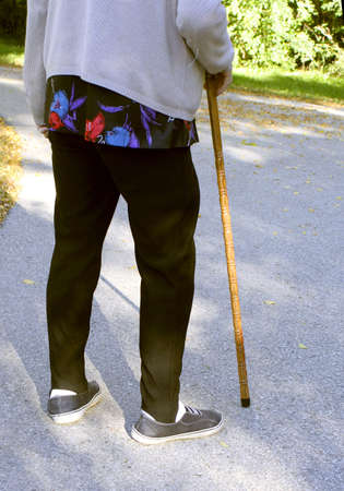 elderly woman with a cane to help with walkingの写真素材