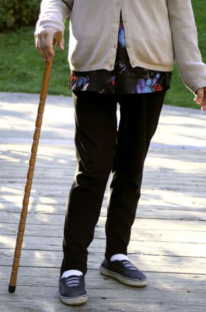 elderly woman with a cane to help with walkingの写真素材