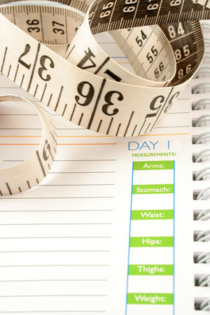 a measuring tape, diet and nutrition journal