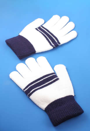warm, wooly winter mittens on purple backgroundの写真素材