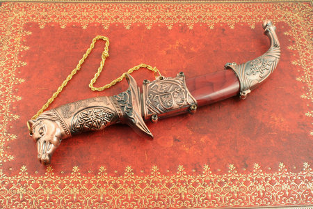 decorative asian knife with horses head and shield