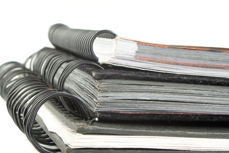 a pile of metal ring binder notebooks