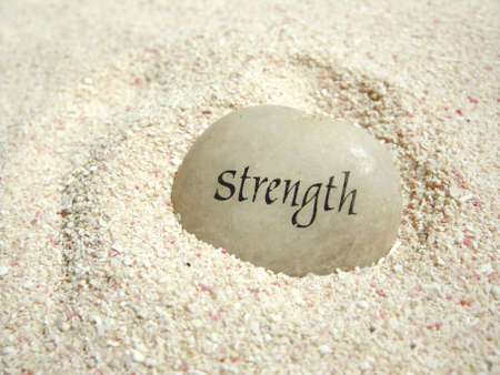 a strength stone in the sand on a beach         の写真素材