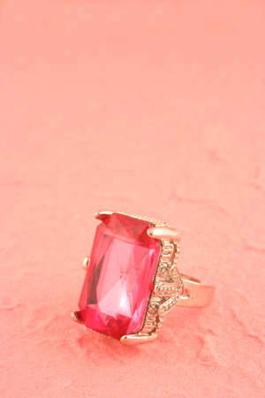 large pink stone engagement ring on pink backgroundの写真素材