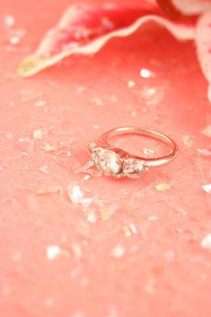 sparkling engagement ring surrounded by glitter confettiの写真素材
