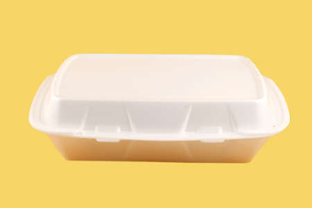 styrofoam take-out food container on a yellow backgroundの写真素材