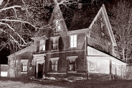 spooky, broken down, glowing abandoned house in  a rural property, great for halloweenの写真素材