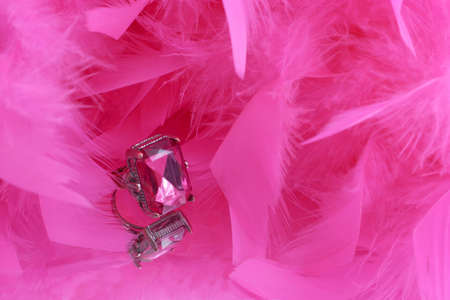 glamorous pink diamond ring and on vanity mirror with a pink feather boa in the backgroundの写真素材