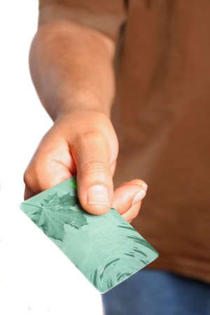 man handing over a plastic credit or debit card の写真素材