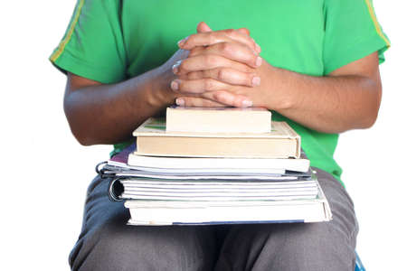 African American college male student with books on his lap and crossed handsの写真素材
