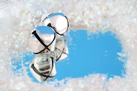 silver bells with reflection surrounded by fake snowの写真素材