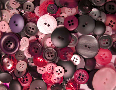 assortment of buttons in different shades of red and pinkの写真素材