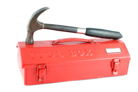 red tool box on a white background with hammer on the lid