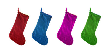 different colored festive  christmas stockings isolated on whiteの写真素材