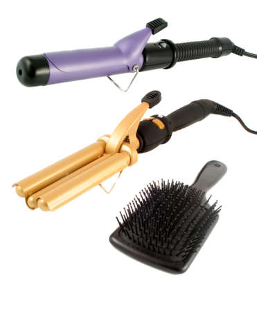 single and triple barrel curling irons used on straight hair to make it curly or wavy and flat hairbrush ready for hairstylingの写真素材