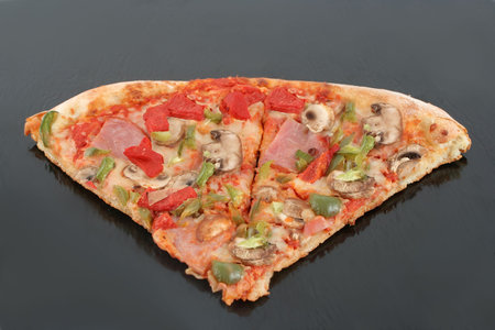 slices of  ham with mushrooms and colorful pepper pizza  on a dark grey  background
