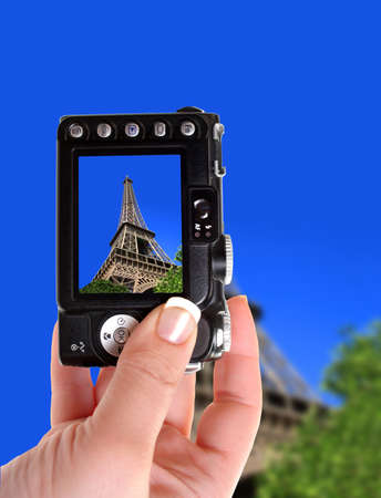 Taking a snapshot of the Eiffel  Tower, Paris, France under a sunny, clear, bright blue skyの写真素材