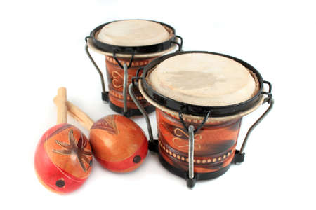 Rhythm percussion instruments like maracas and bongo drums on a white backgroundの写真素材