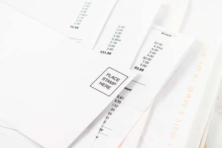 Different bills to be paid with blank envelope on top to mail prompt paymentsの写真素材