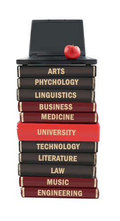University level subject textbooks stacked on a laptop with apple on a white backgroundの写真素材