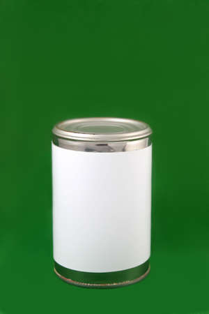 Aluminum tin can with blank label on a green backgroundの写真素材