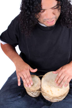 Funky long haired ethnic African American and Native Indian male playing bongo drums on a white backgroundの写真素材
